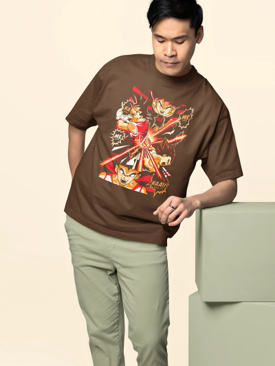 Man wearing a brown t-shirt with a graphic design, standing against a beige background