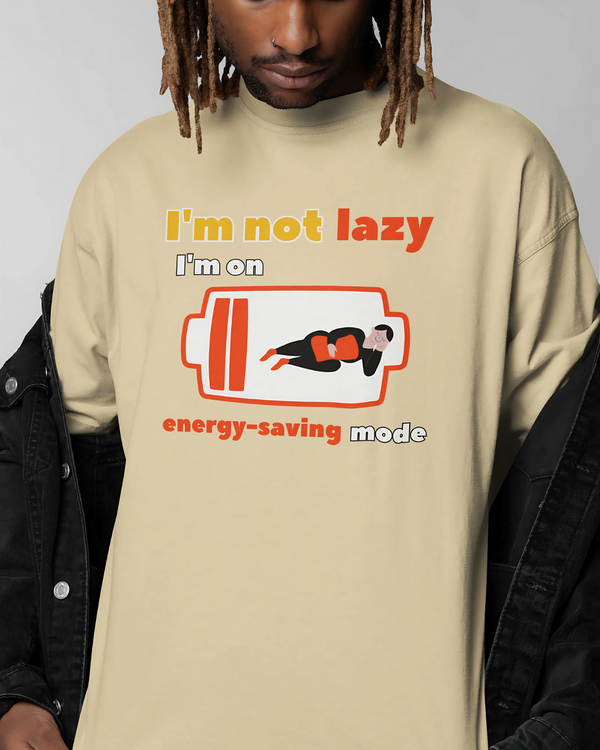 Person wearing a beige t-shirt with a humorous graphic and text.